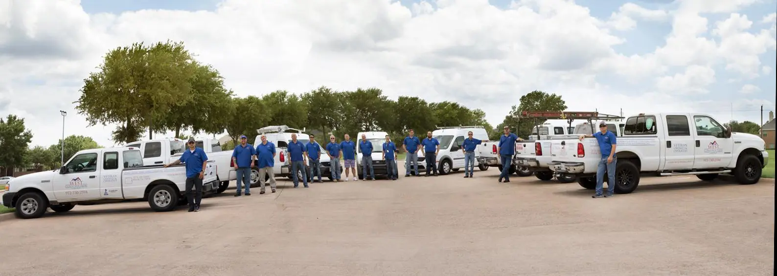 Group of workers with white pickup trucks.