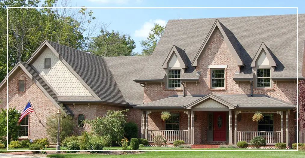 Brick house with a front porch and garden.